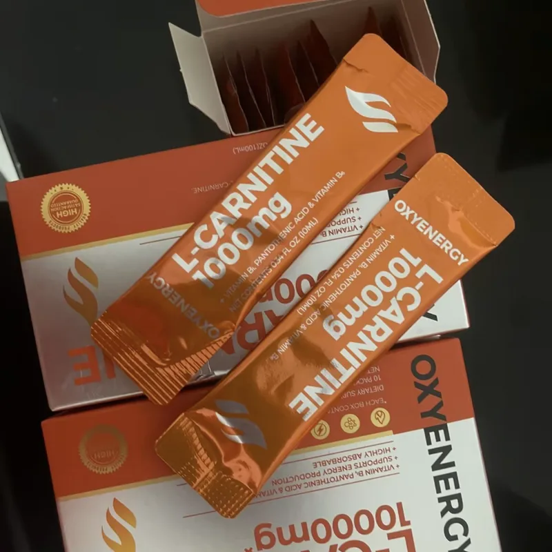 Buyer's photo — two L-Carnitine boxes with two orange sachets laid across them