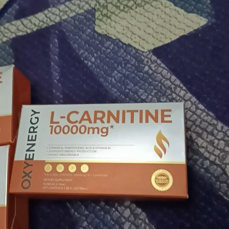 Buyer's photo — an L-Carnitine 10000mg box on a bedsheet