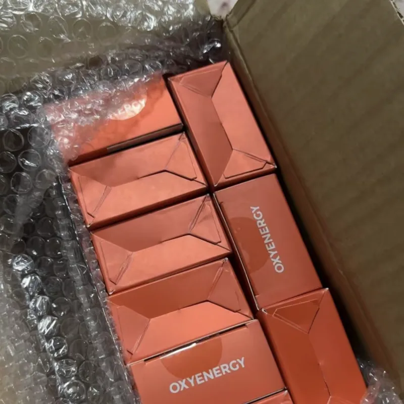 Buyer's photo — nine OXYENERGY boxes standing upright in a shipping carton
